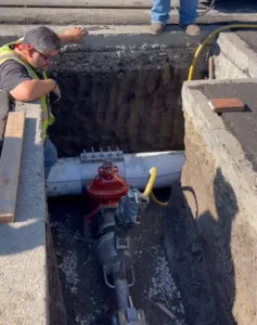 CIty Workers' using a Hot Tapping Machine performing a hot top into a 10" water main.